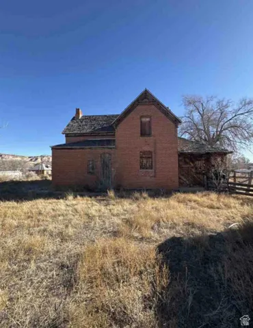 View of home's exterior featuring a chimney and brick siding
