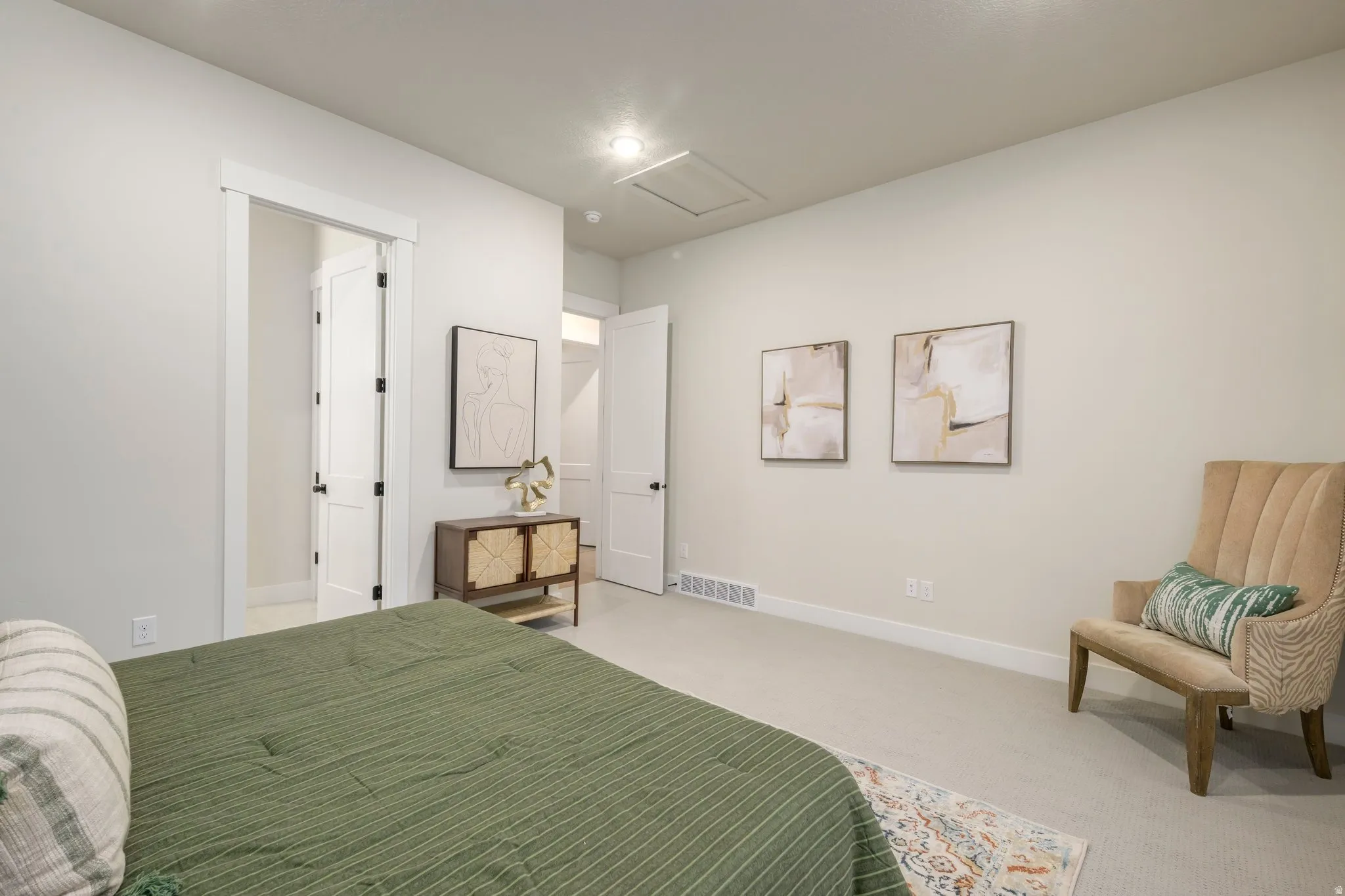 Bedroom with attic access and carpet floors