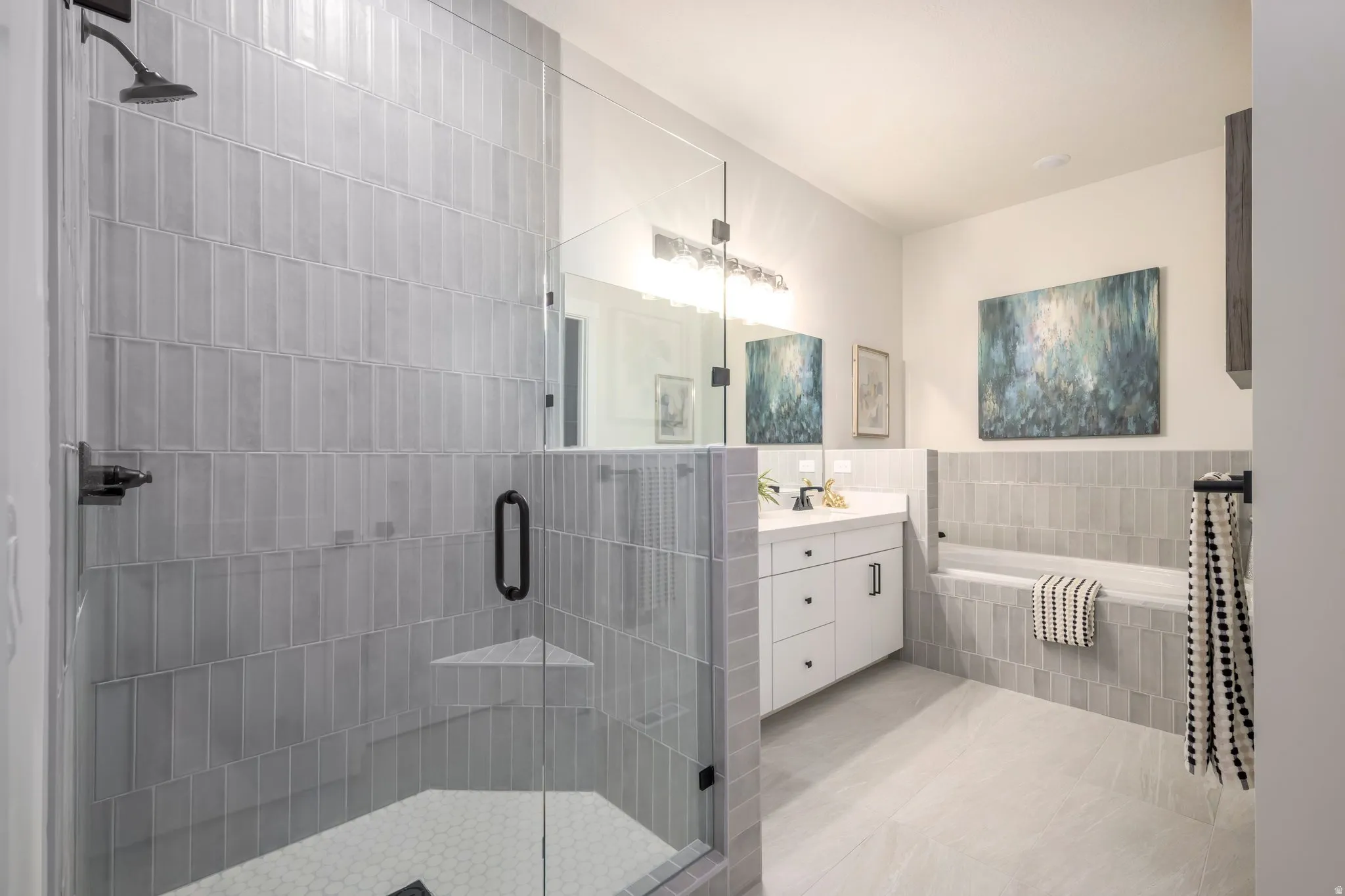 Bathroom featuring a bath, a shower stall, vanity, and light tile patterned floors