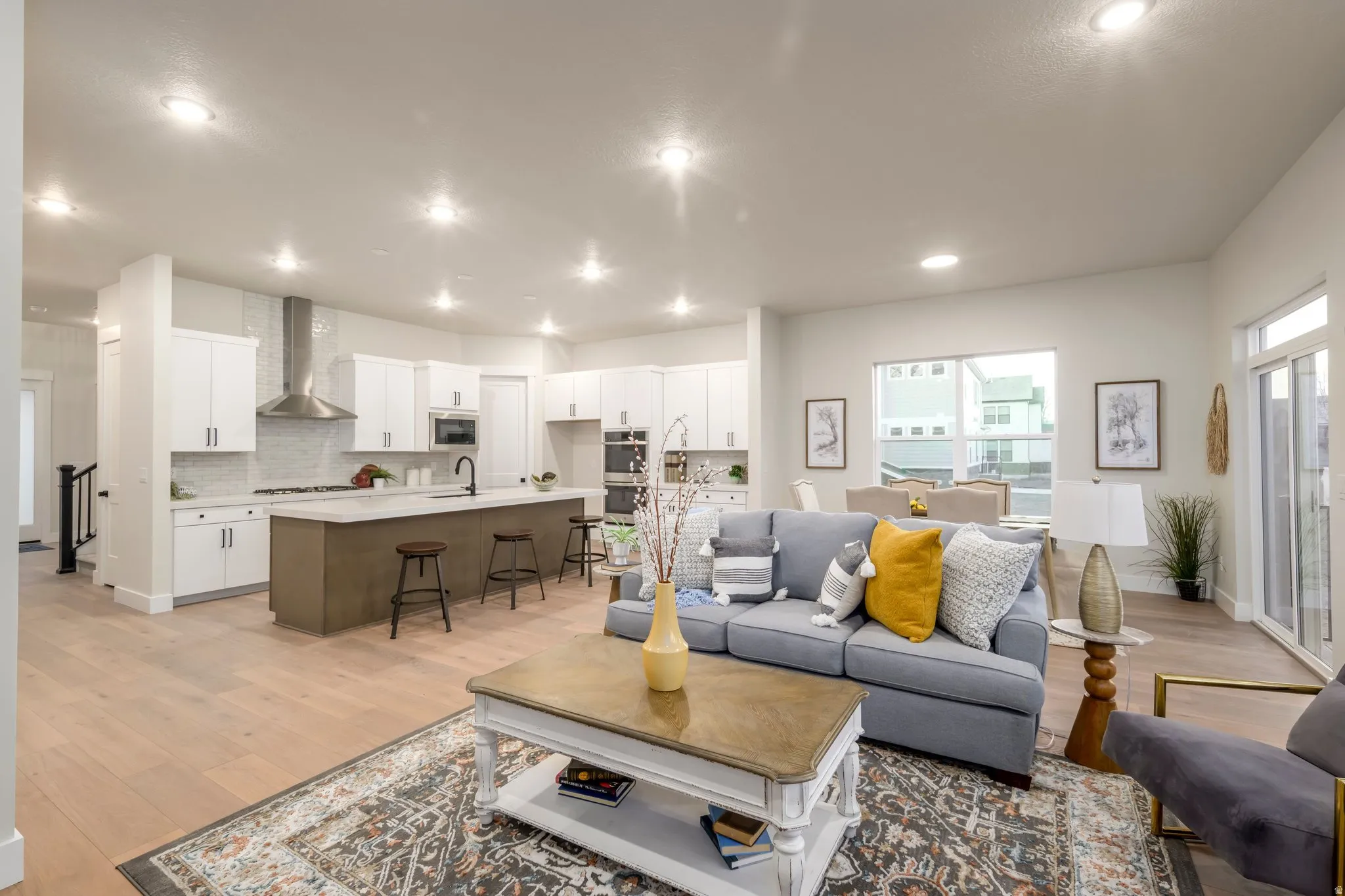 Living area featuring light wood-style floors and recessed lighting