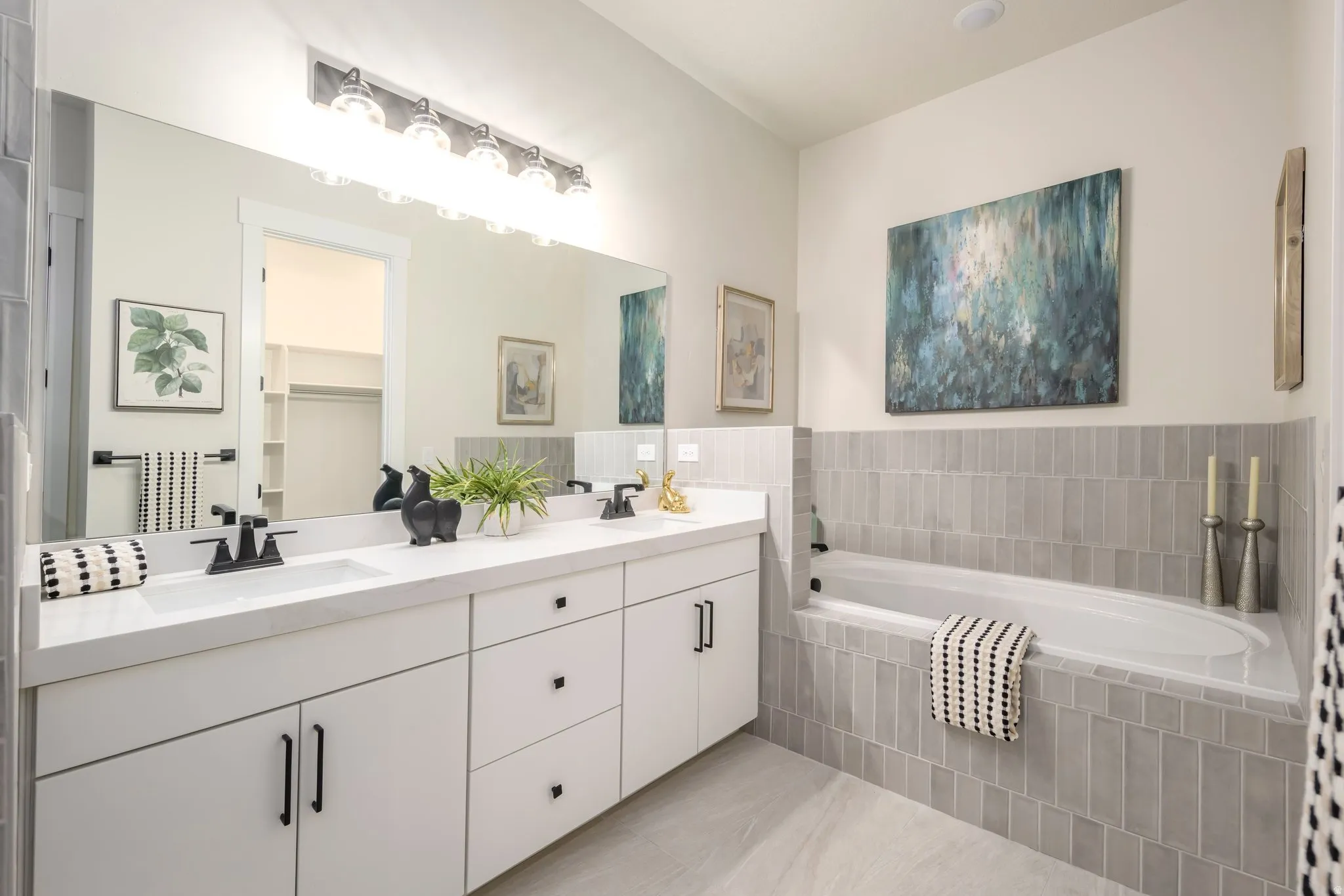 Full bath with double vanity and a garden tub