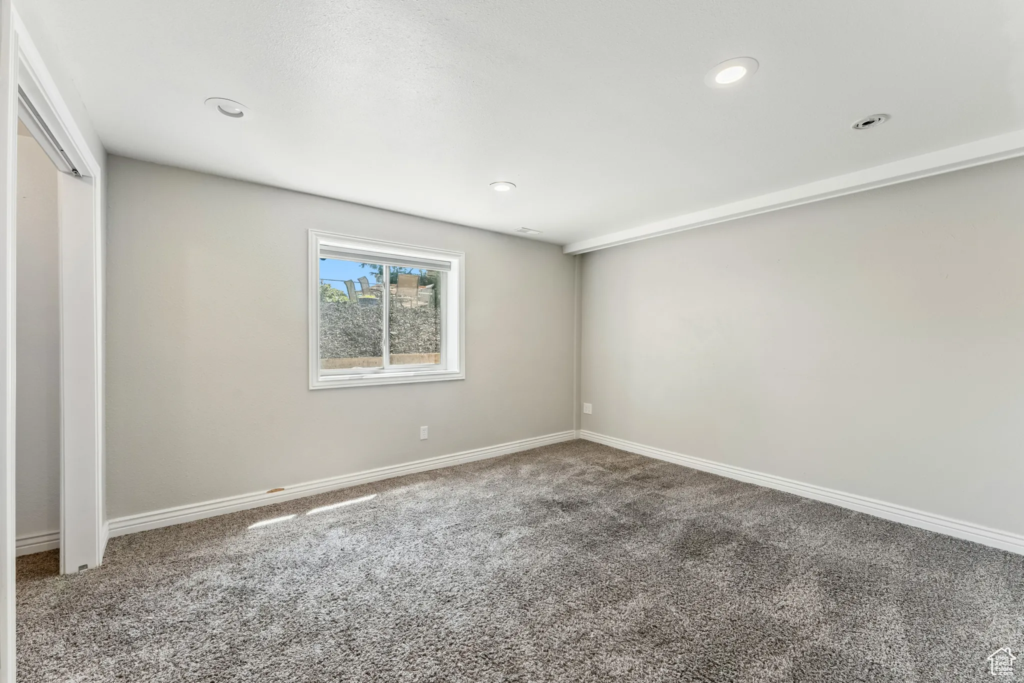 Unfurnished room with carpet floors and recessed lighting