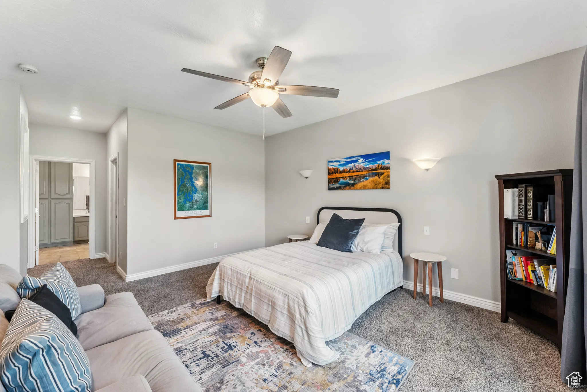 Bedroom with carpet flooring, ceiling fan, and ensuite bathroom