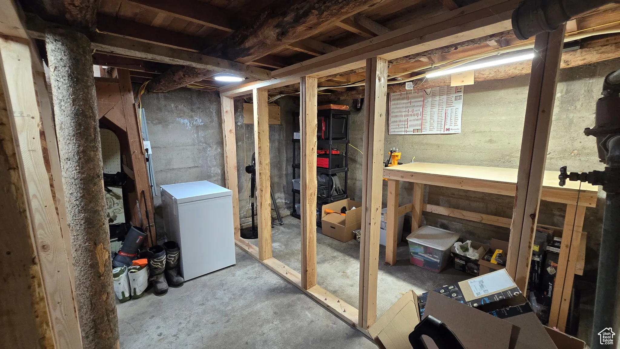 Unfinished basement with fridge