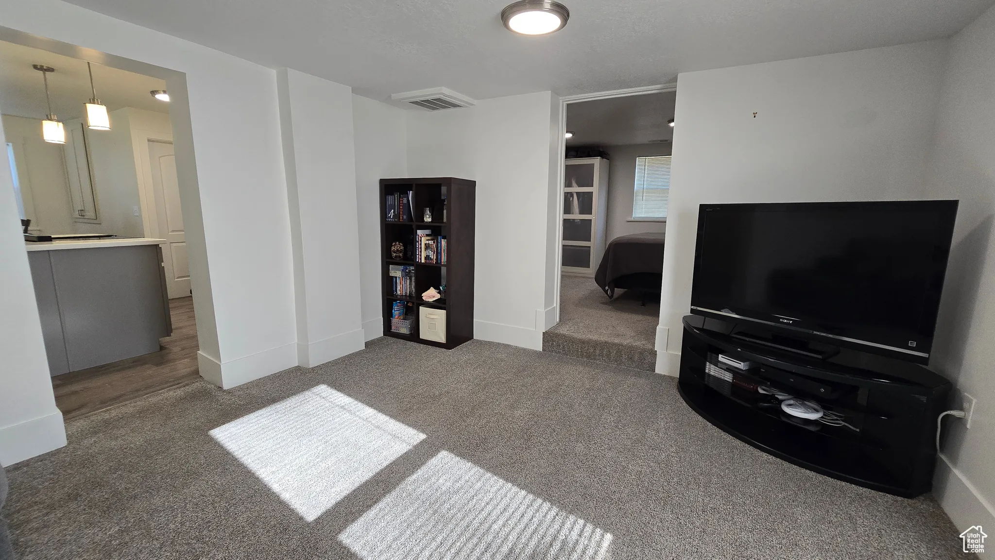 Living area featuring carpet and baseboards