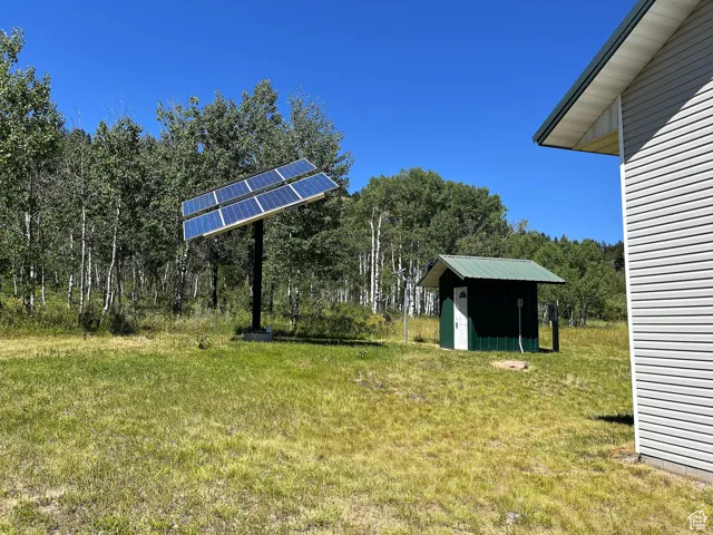 View of grassy yard featuring a shed