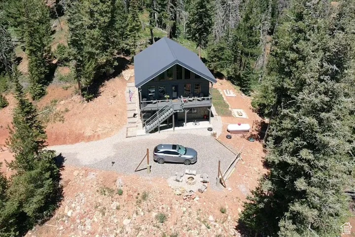 Aerial view of property and surrounding area featuring a heavily wooded area