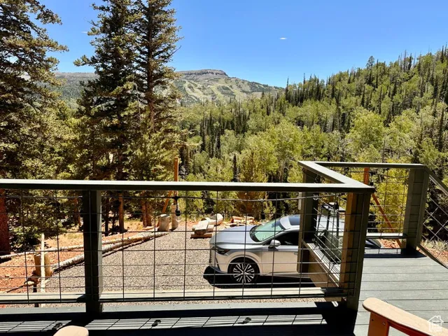Balcony featuring a view of trees