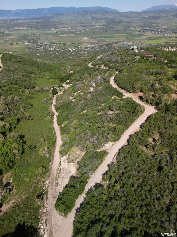Aerial view of property and surrounding area featuring mountains