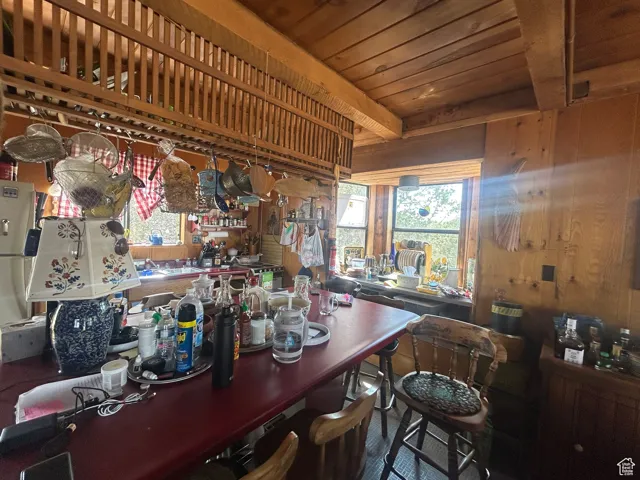 Bar area featuring wood walls, a workshop area, and wooden ceiling