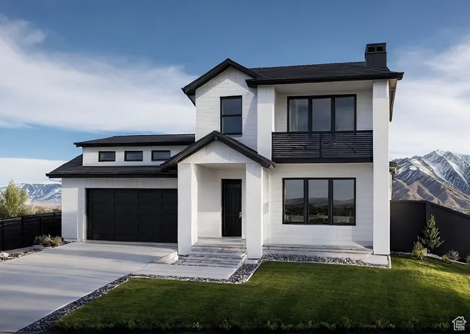 View of front of home featuring a mountain view, driveway, and a chimney