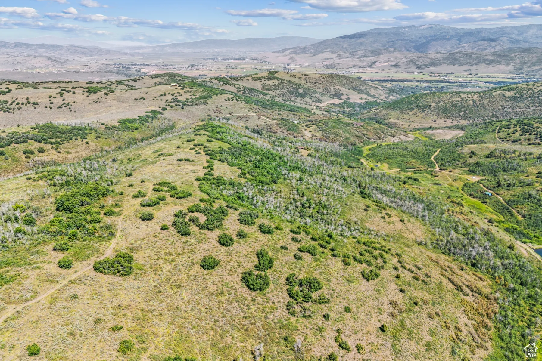 Aerial view of property's location with a mountainous background and rural landscape