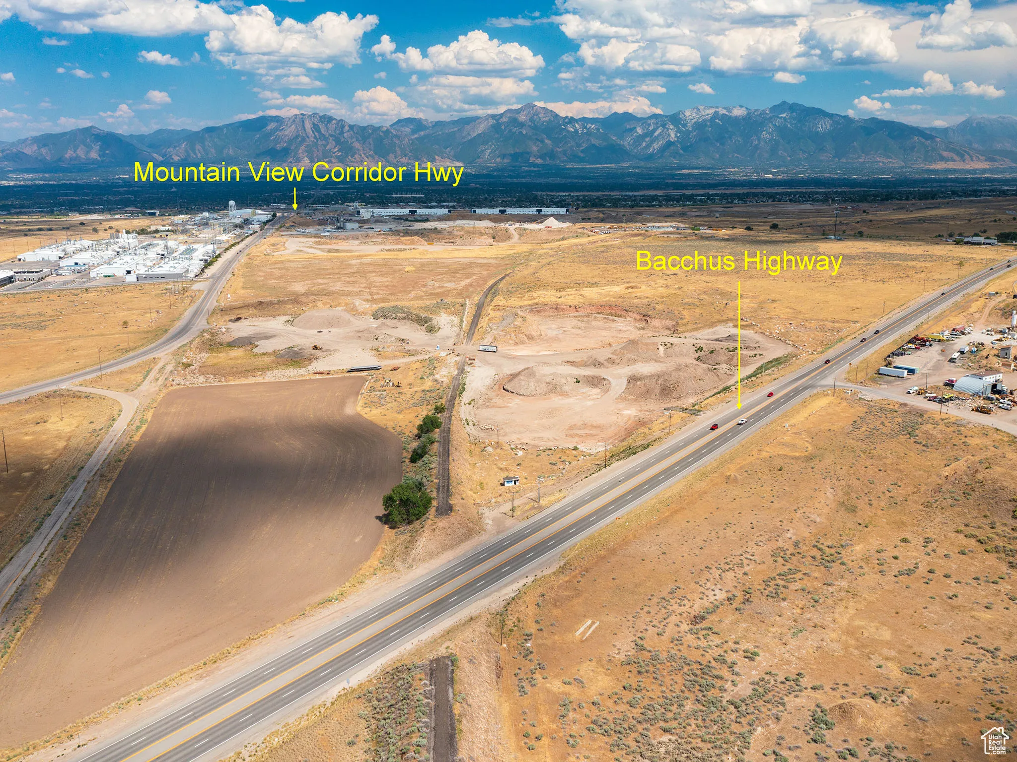 Aerial view of sparsely populated area featuring a mountainous background and property parcel outlined