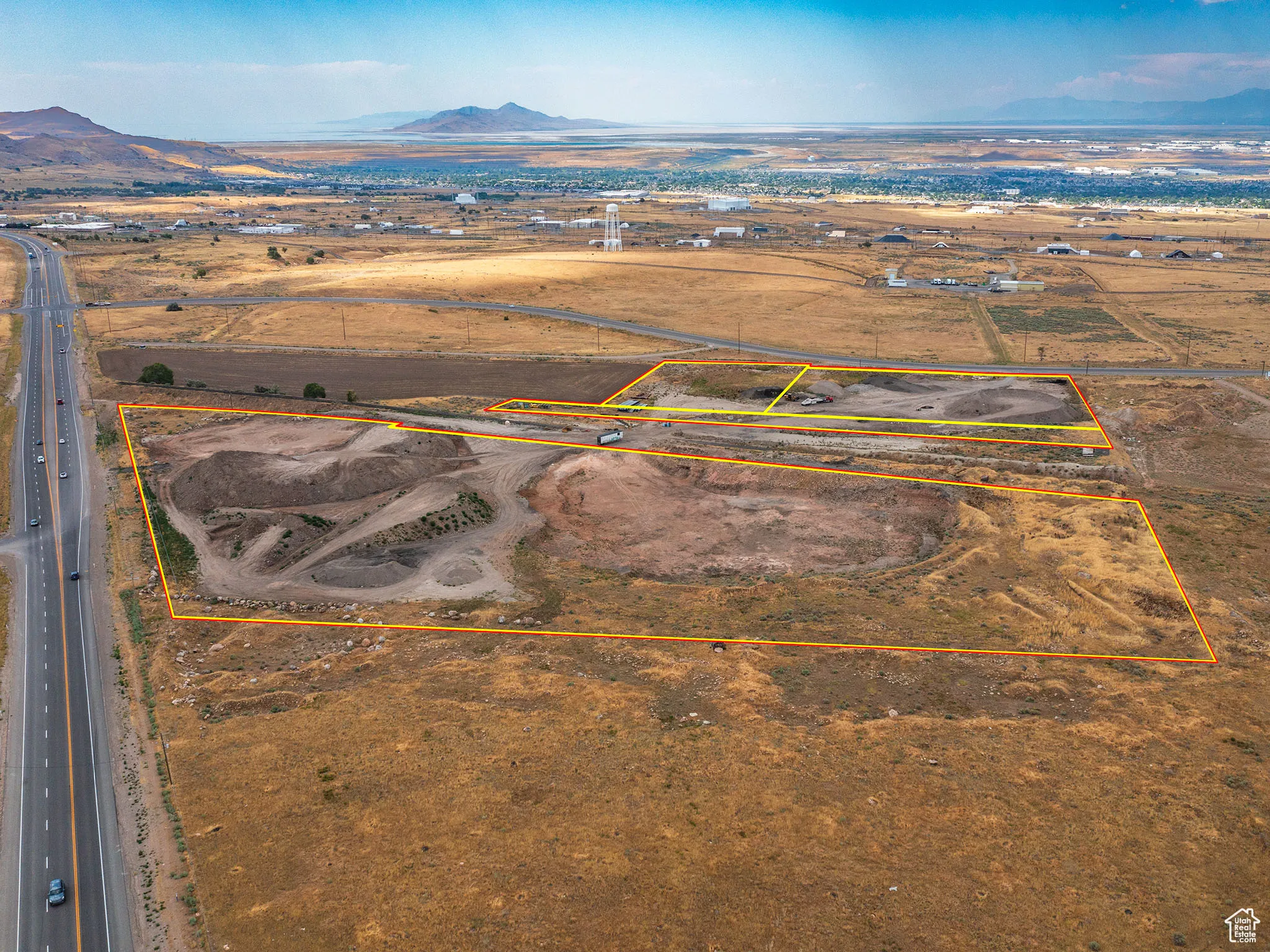 Aerial view of sparsely populated area with a mountainous background and property boundaries highlighted