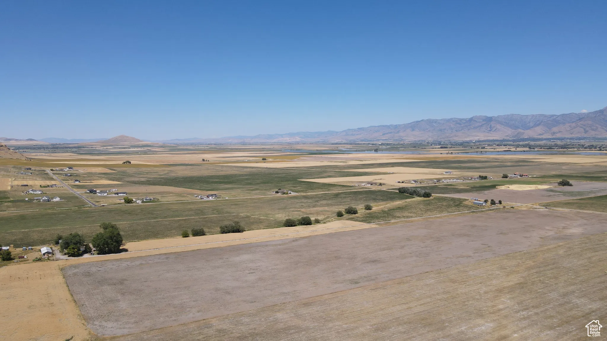 View of mountain background with a nearby body of water and rural landscape