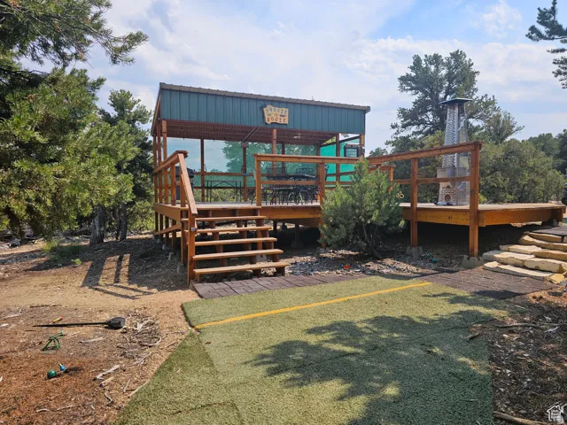 Back of property featuring a wooden deck and stairs