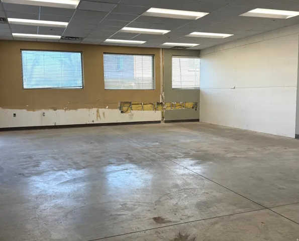Spare room with a drop ceiling and concrete flooring