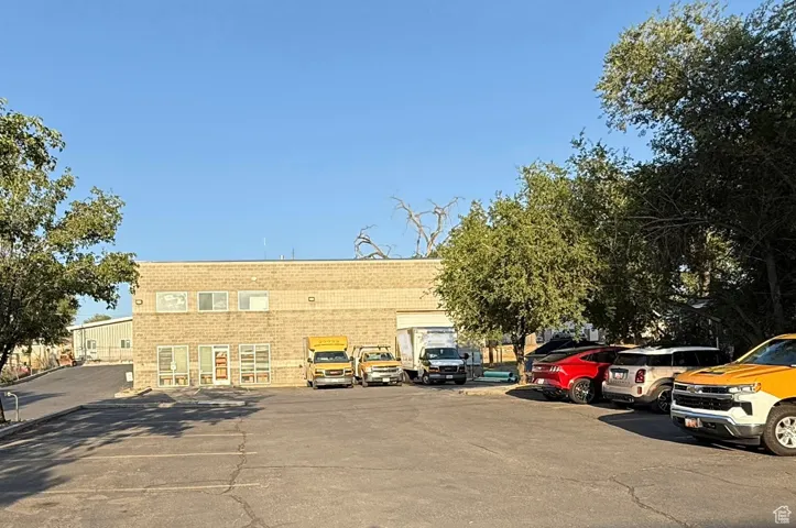 View of building exterior featuring uncovered parking