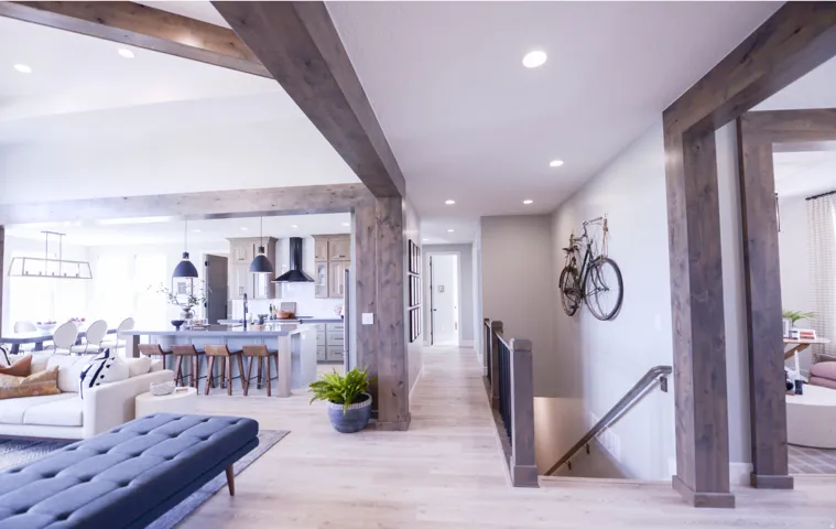 Hall with beamed ceiling, an upstairs landing, light wood-style floors, and recessed lighting