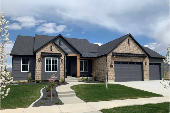 View of front of house featuring a front yard, an attached garage, brick siding, concrete driveway, and a shingled roof