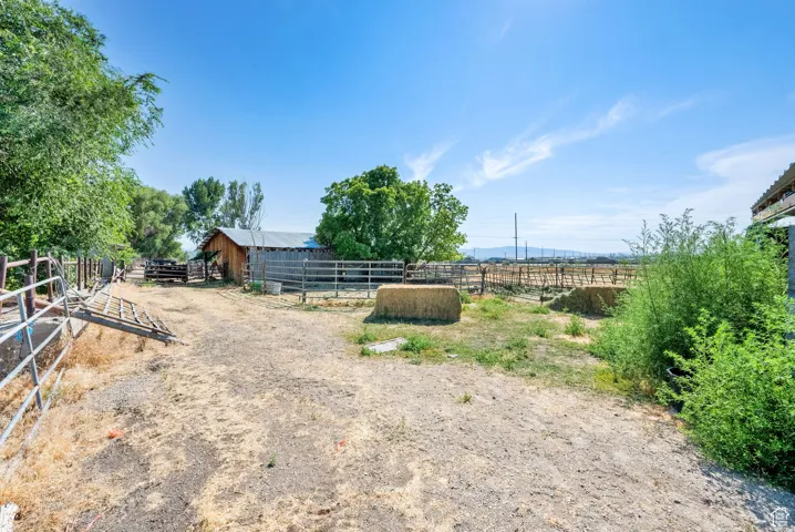 View of yard featuring an exterior structure, a view of rural / pastoral area, and an outdoor structure
