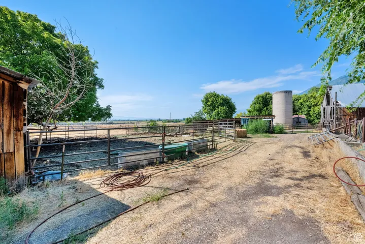 View of yard featuring an exterior structure, a rural view, and an outdoor structure
