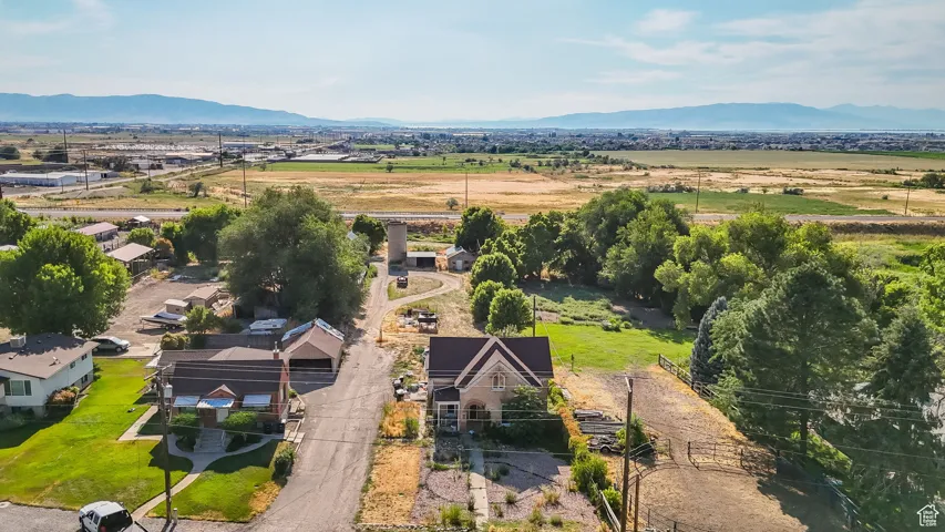 Aerial view of property and surrounding area with a mountainous background
