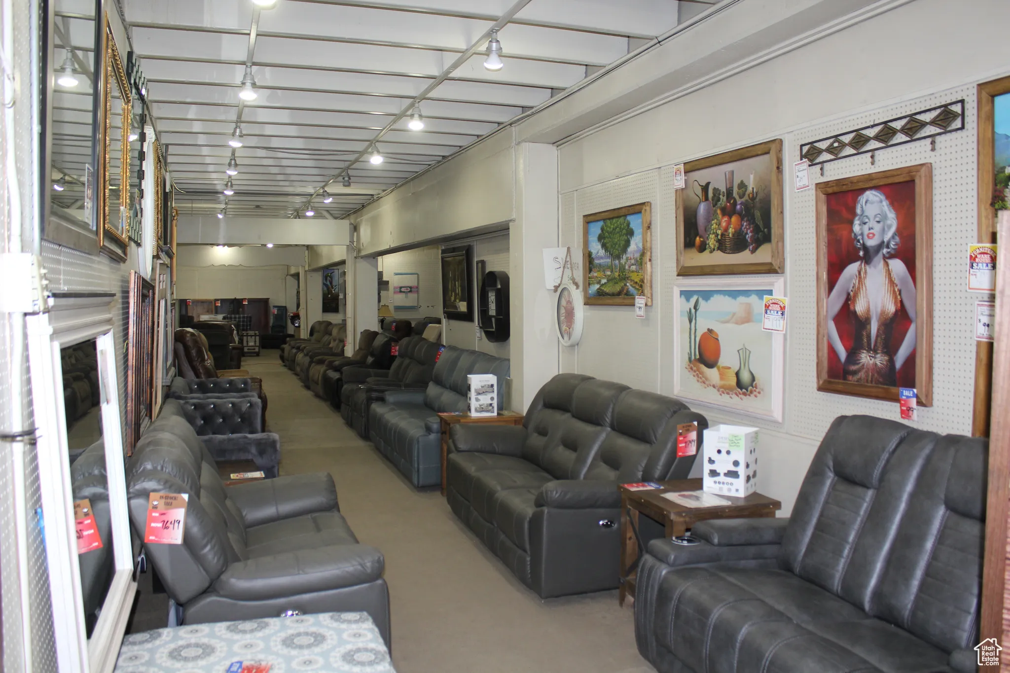 Carpeted living area featuring track lighting