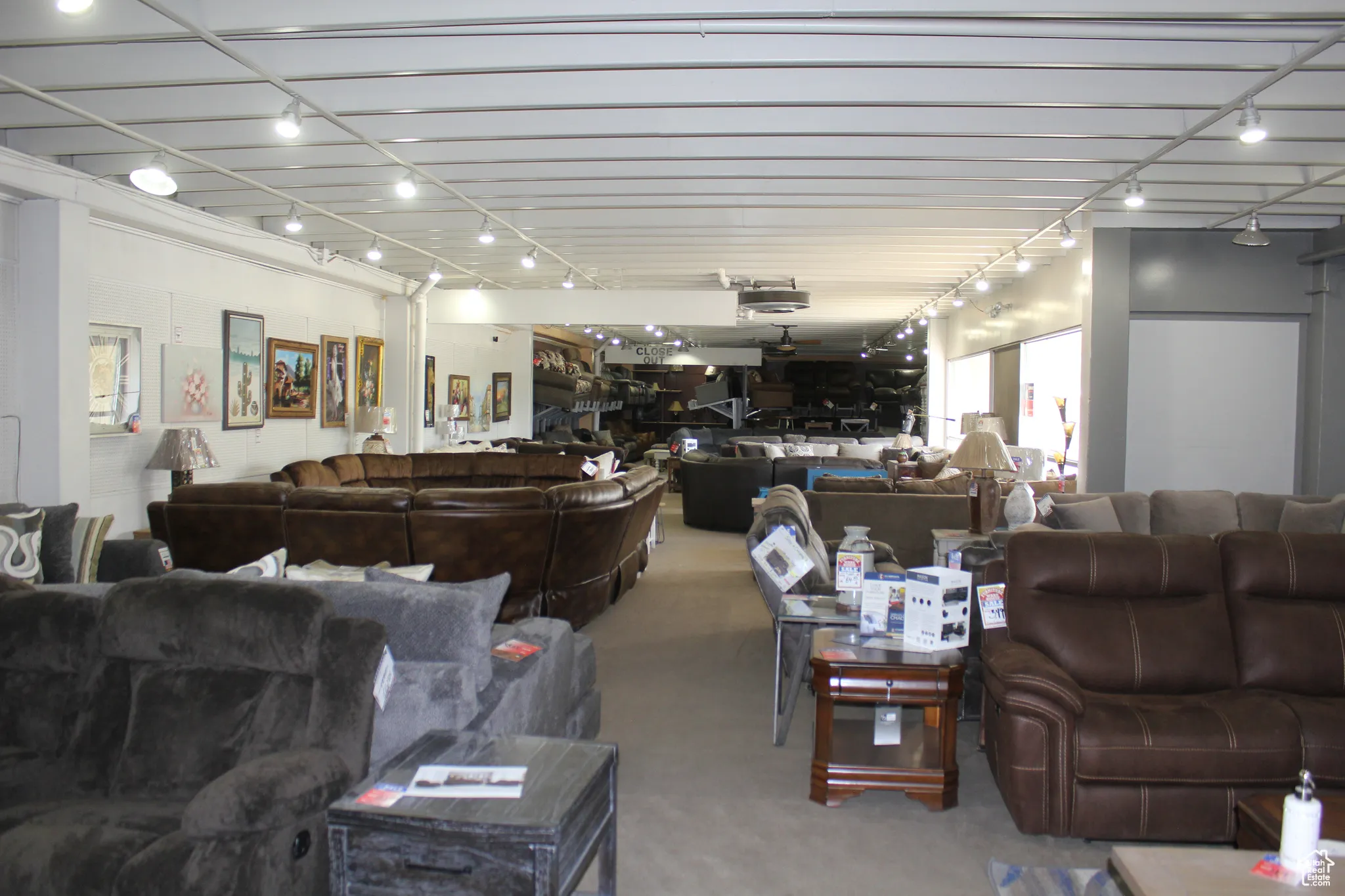 Carpeted living area featuring track lighting