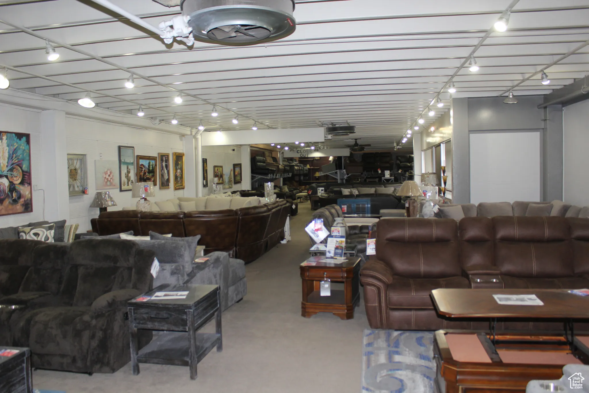Living area featuring rail lighting and carpet