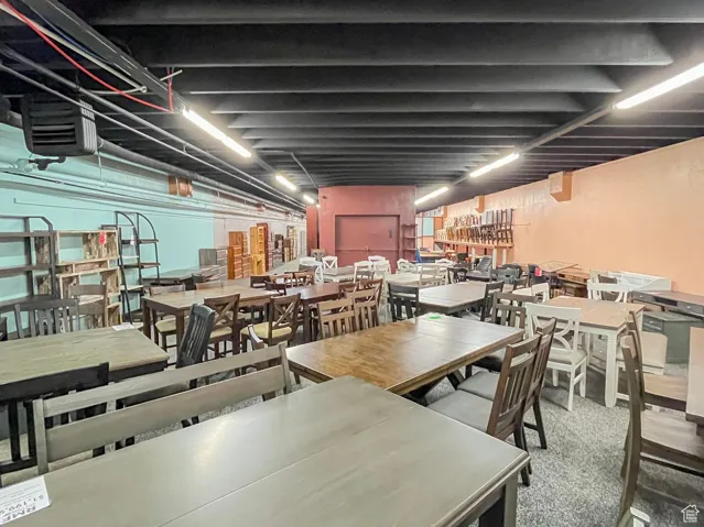 Carpeted dining space featuring a heating unit
