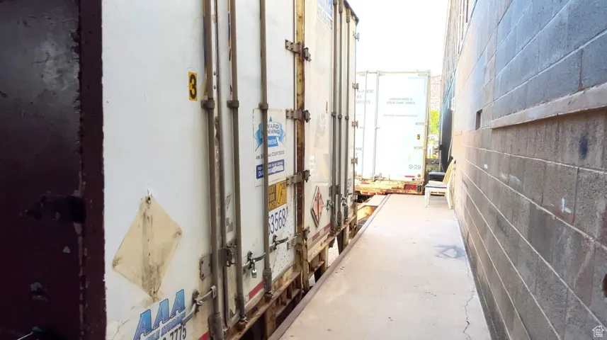 Hall with unfinished concrete floors and concrete block wall