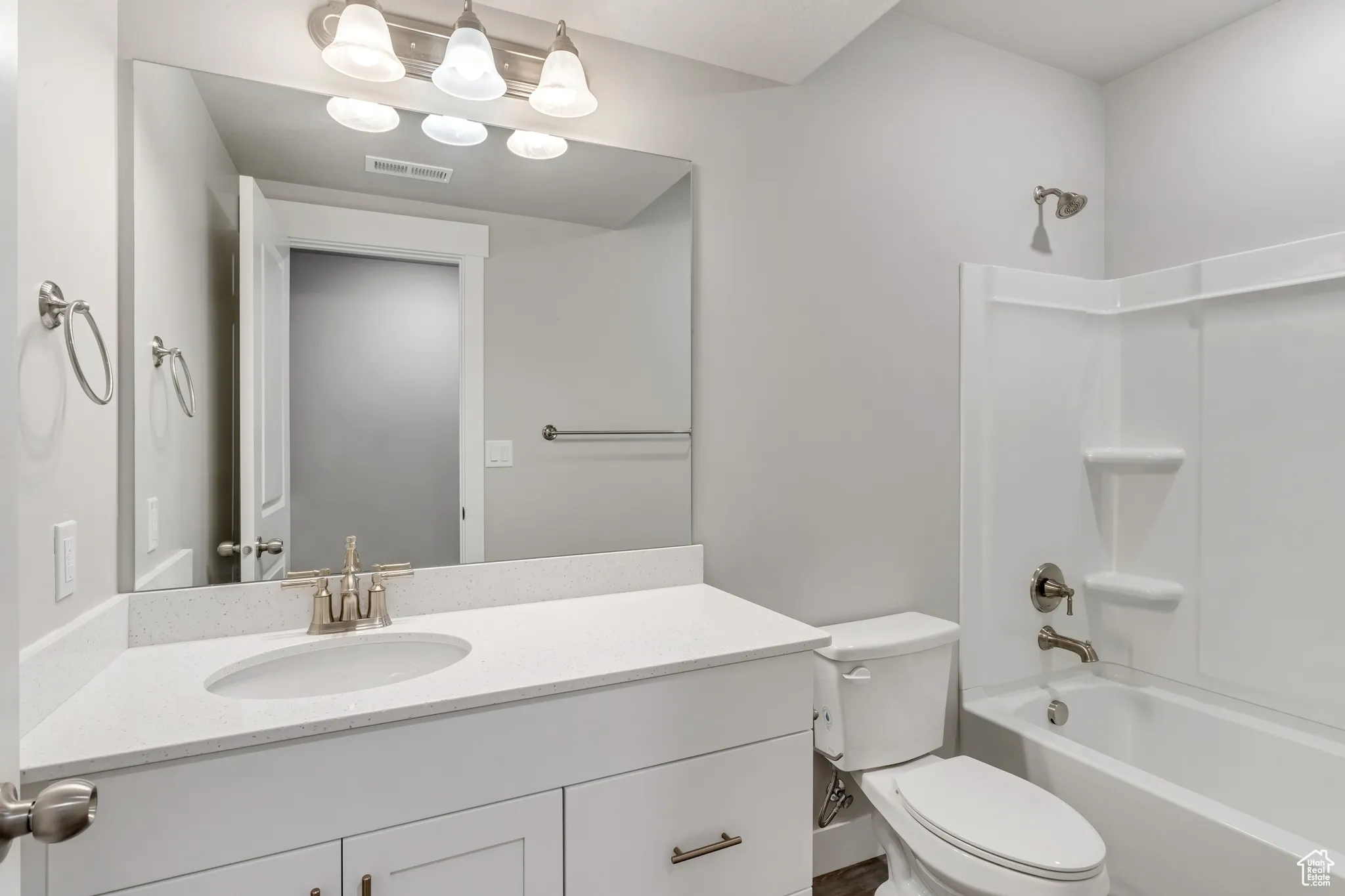 Bathroom featuring vanity and washtub / shower combination