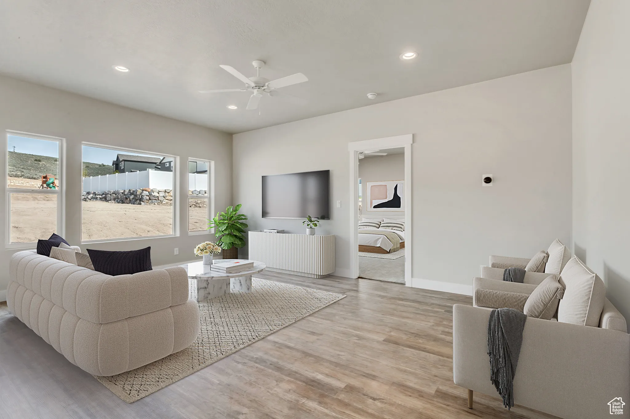 Living room featuring recessed lighting, ceiling fan, and light wood-style floors