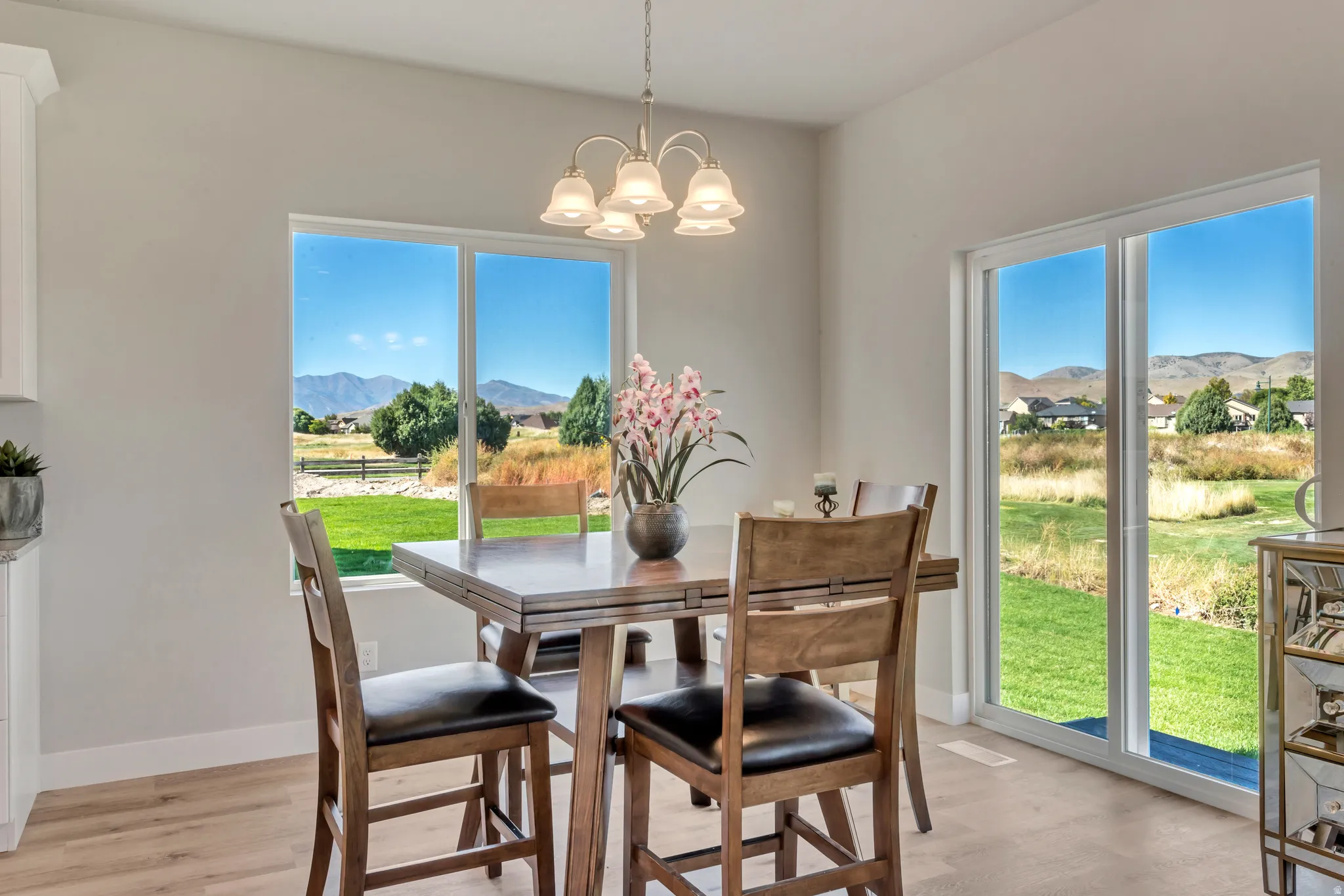 Dining space featuring a mountain view, light wood-style floors, and a chandelier