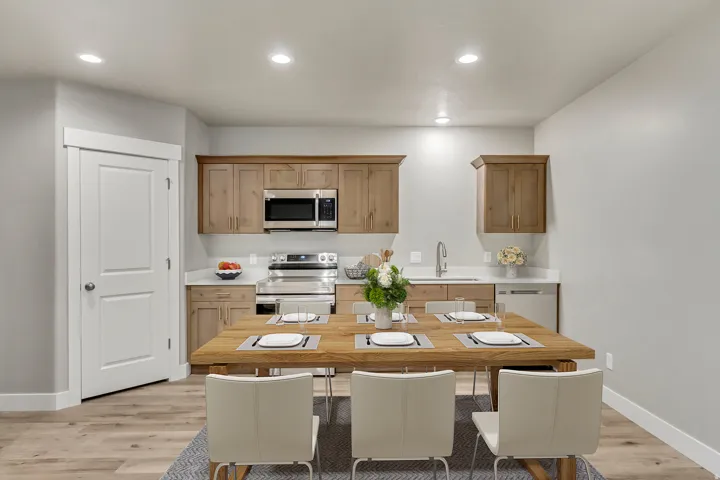 Kitchen with light countertops, stainless steel appliances, light wood-style flooring, recessed lighting, and brown cabinetry
