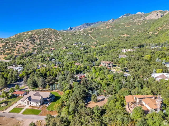 Aerial view of property and surrounding area featuring a mountain backdrop
