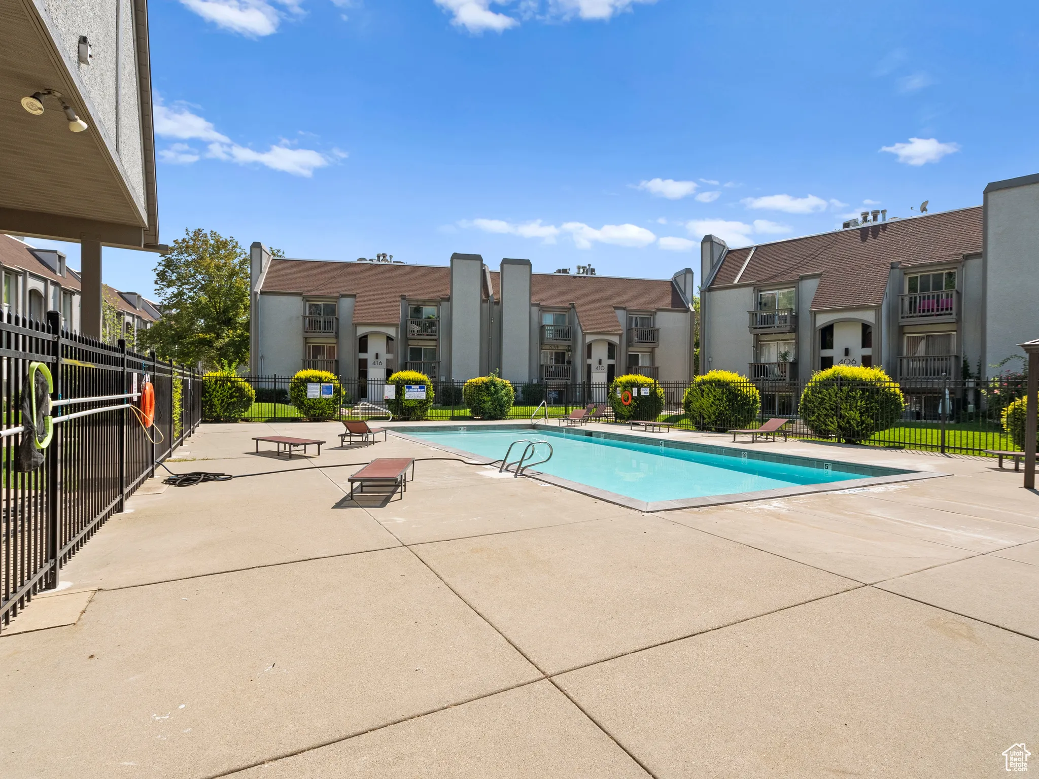 Community pool with a residential view and a patio area
