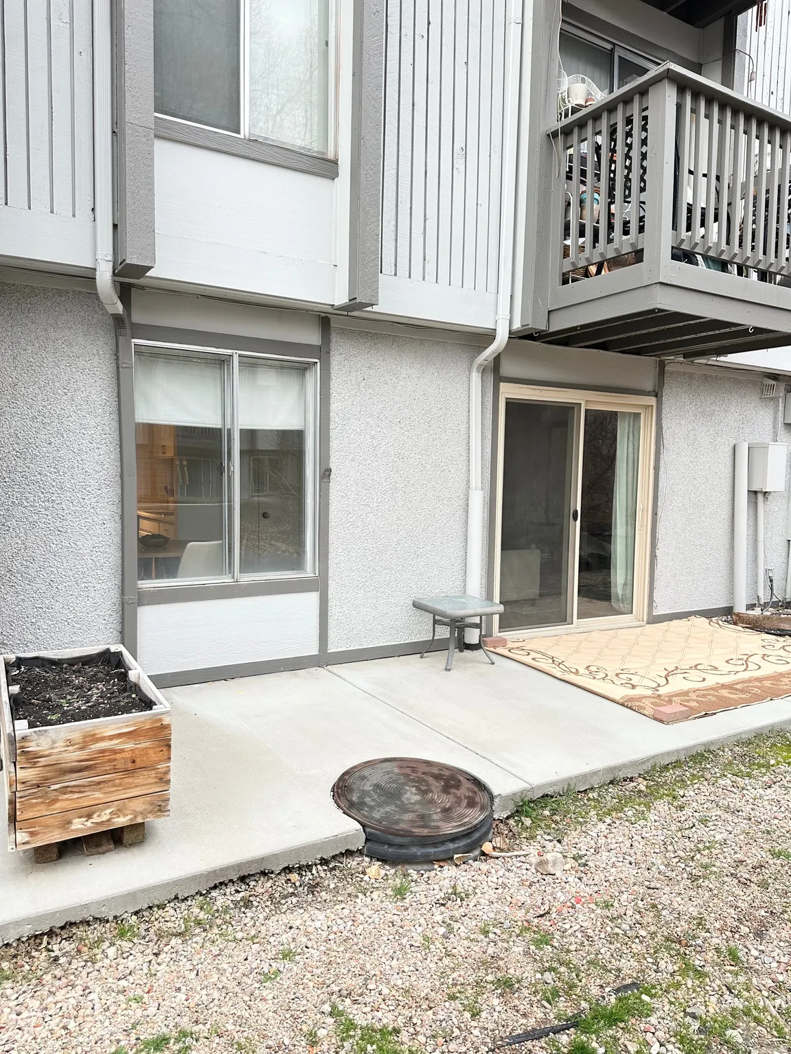 Back of property featuring a patio area, stucco siding, and a balcony