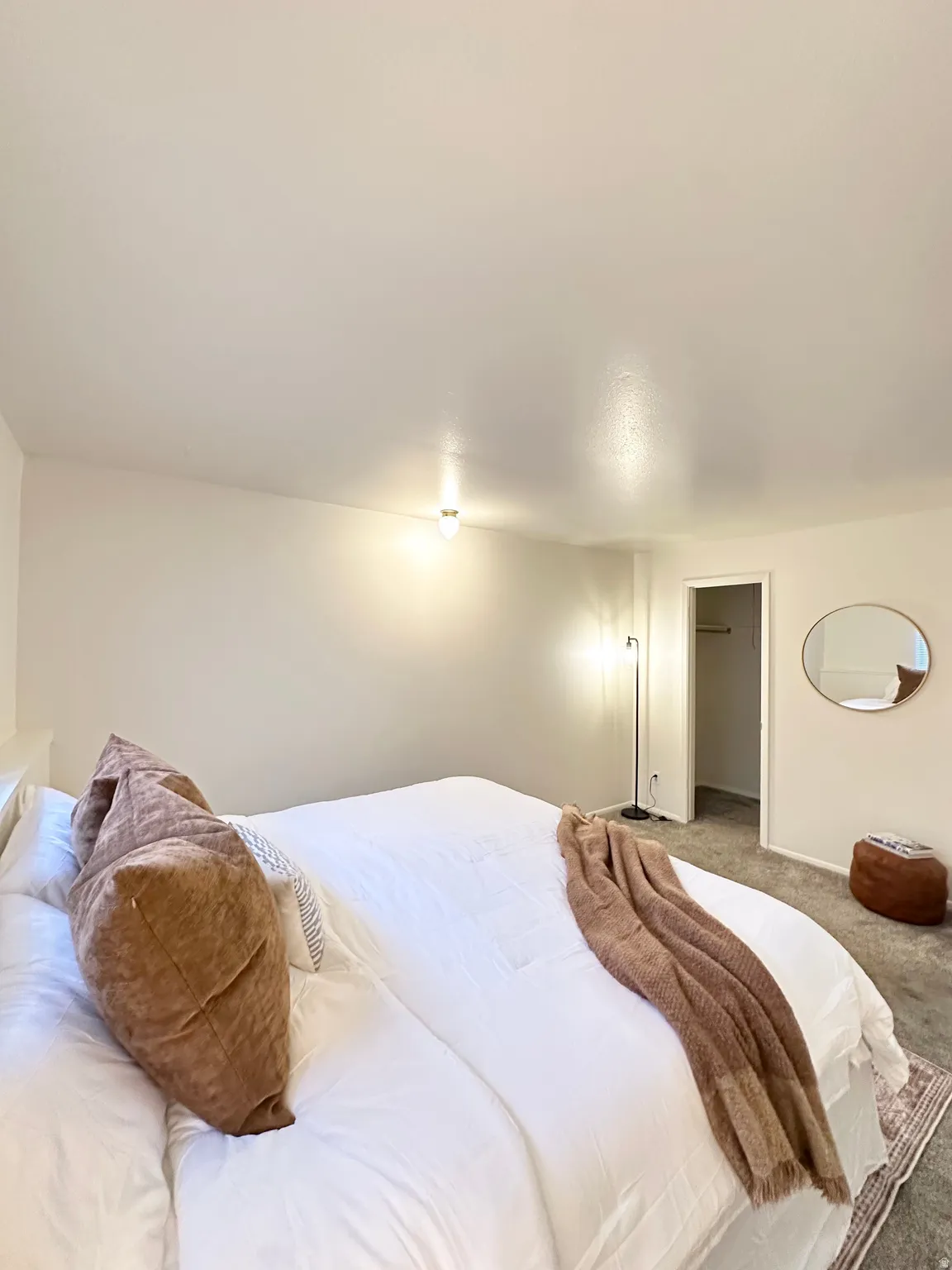 Bedroom with carpet and a walk in closet
