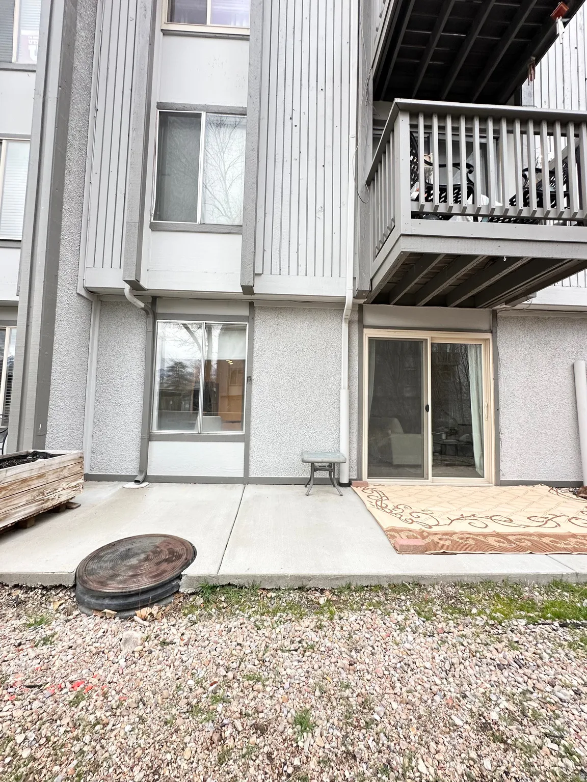 Back of property featuring a patio, a balcony, and stucco siding