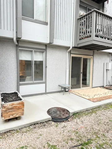 Back of property featuring a patio area, stucco siding, and a balcony
