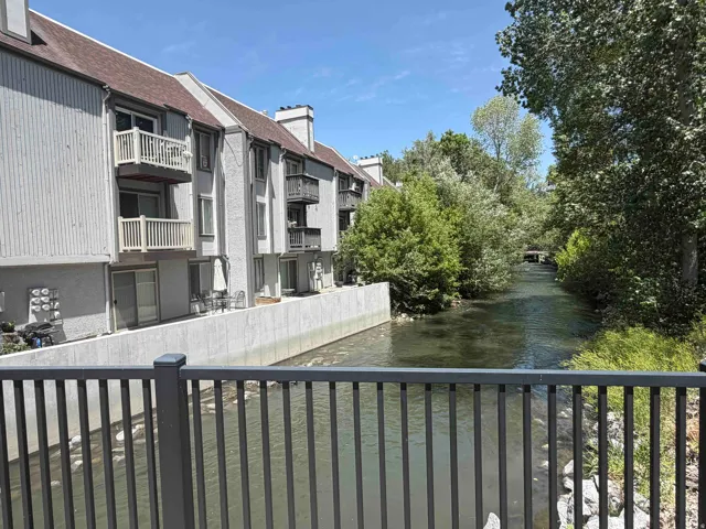 Waterfront residential buildings featuring multiple private balconies and ground-level patios