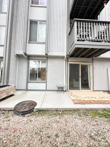 Back of property featuring a patio, a balcony, and stucco siding