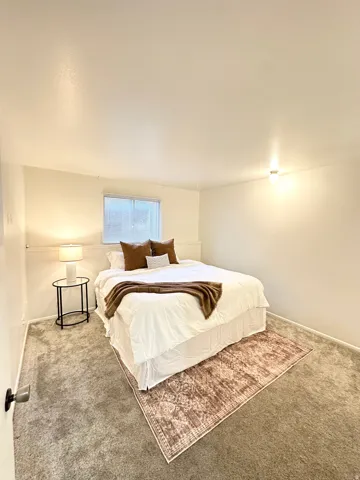 Bedroom with carpet floors and baseboards