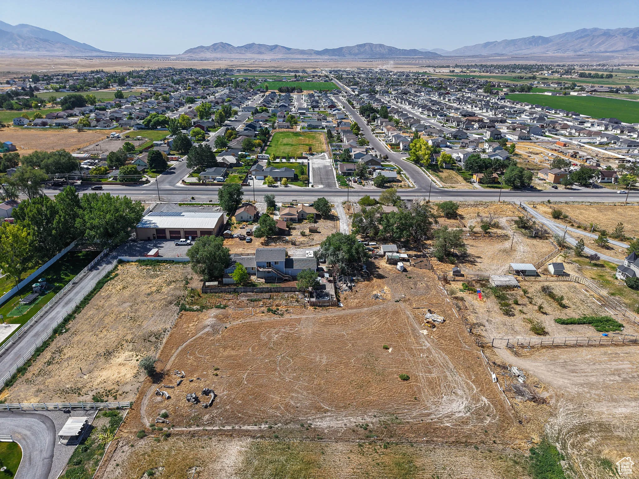 Aerial view of property and surrounding area featuring mountains