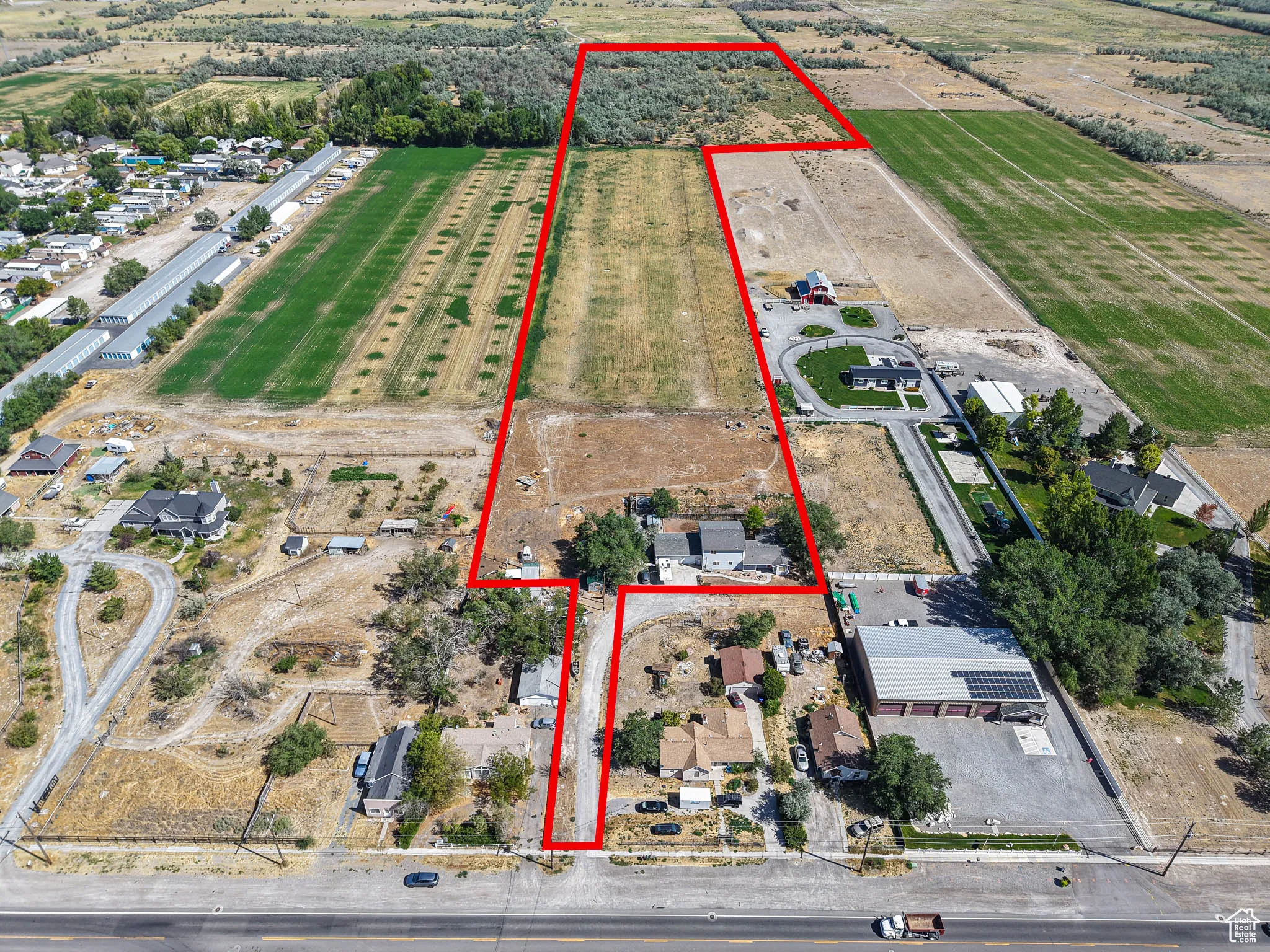 Aerial view of sparsely populated area featuring property parcel outlined