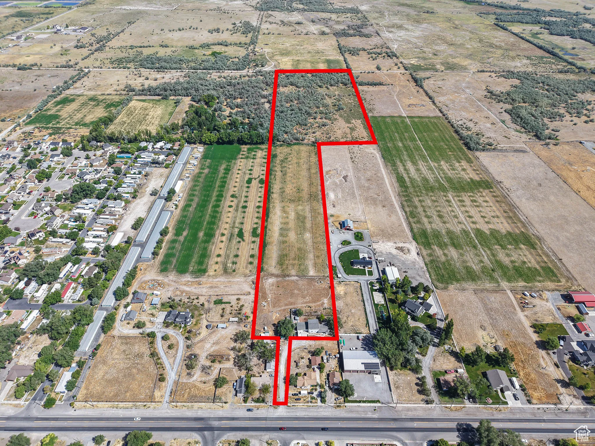 Aerial overview of property's location with property parcel outlined and rural landscape