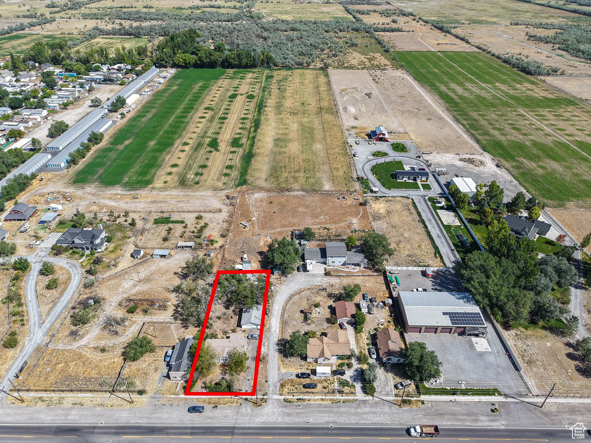 Aerial view of property and surrounding area with property parcel outlined and rural landscape