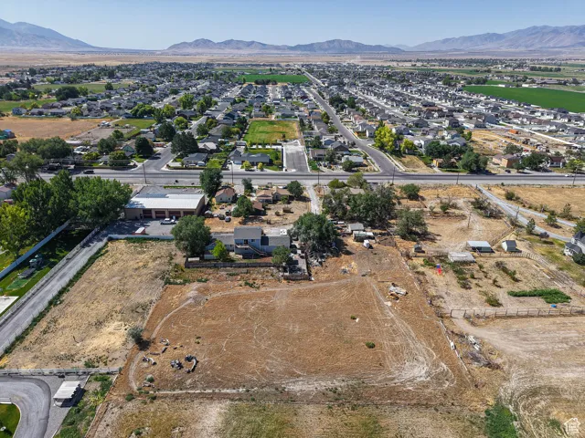 Aerial view of property and surrounding area featuring mountains